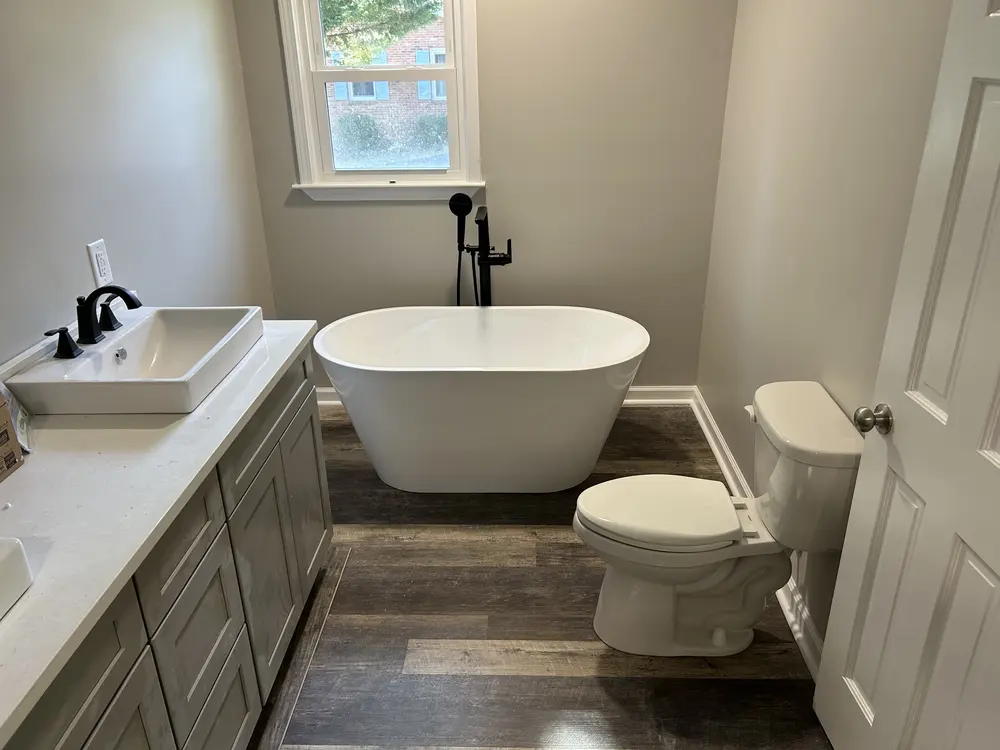 Bathroom with a freestanding tub, vessel sink and toilet